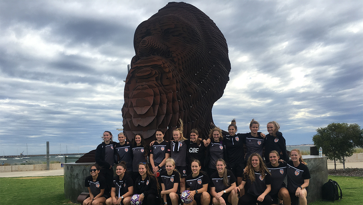 Players at statue in Bunbury